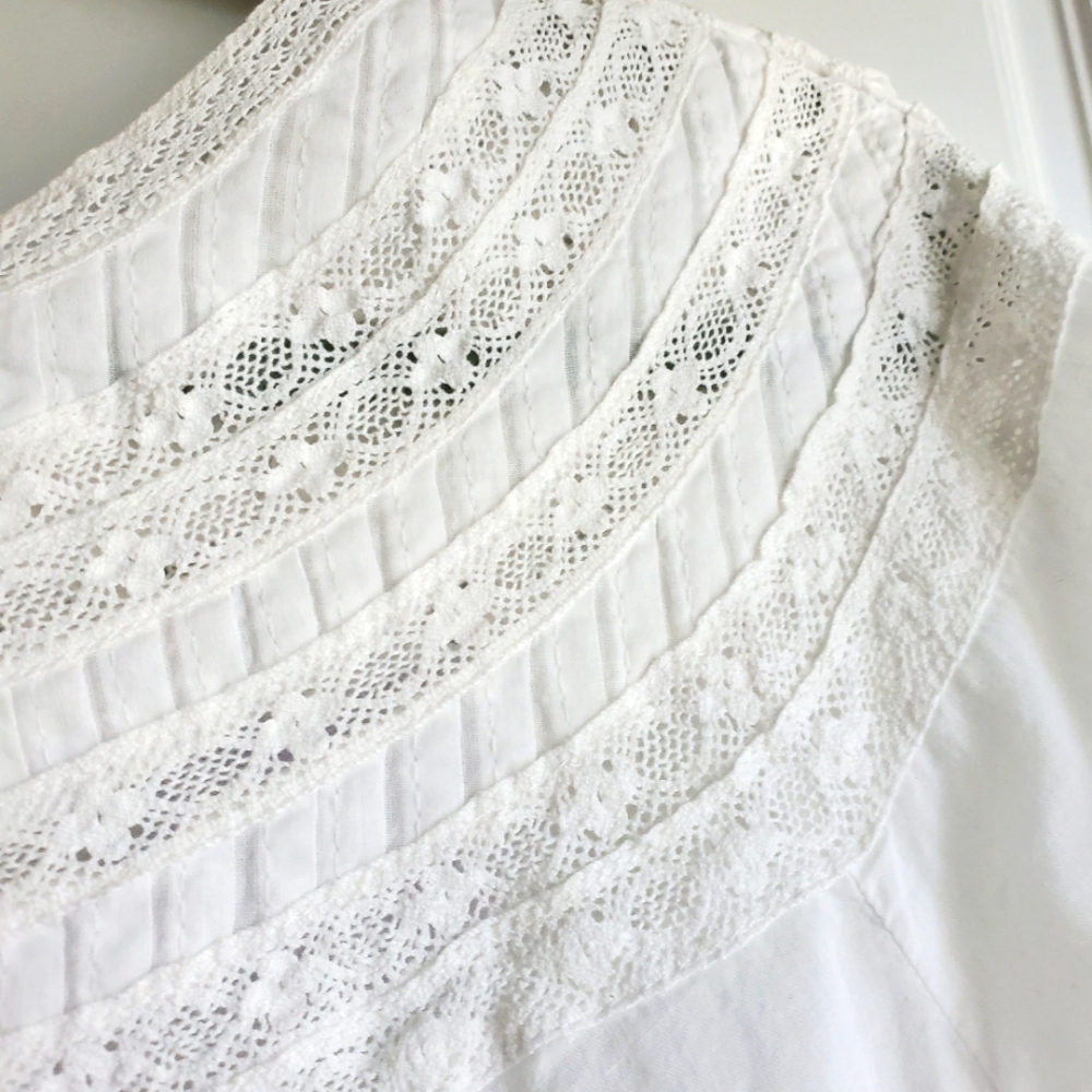 Charming blouse of inset lace and tiny pleats. Never worn.